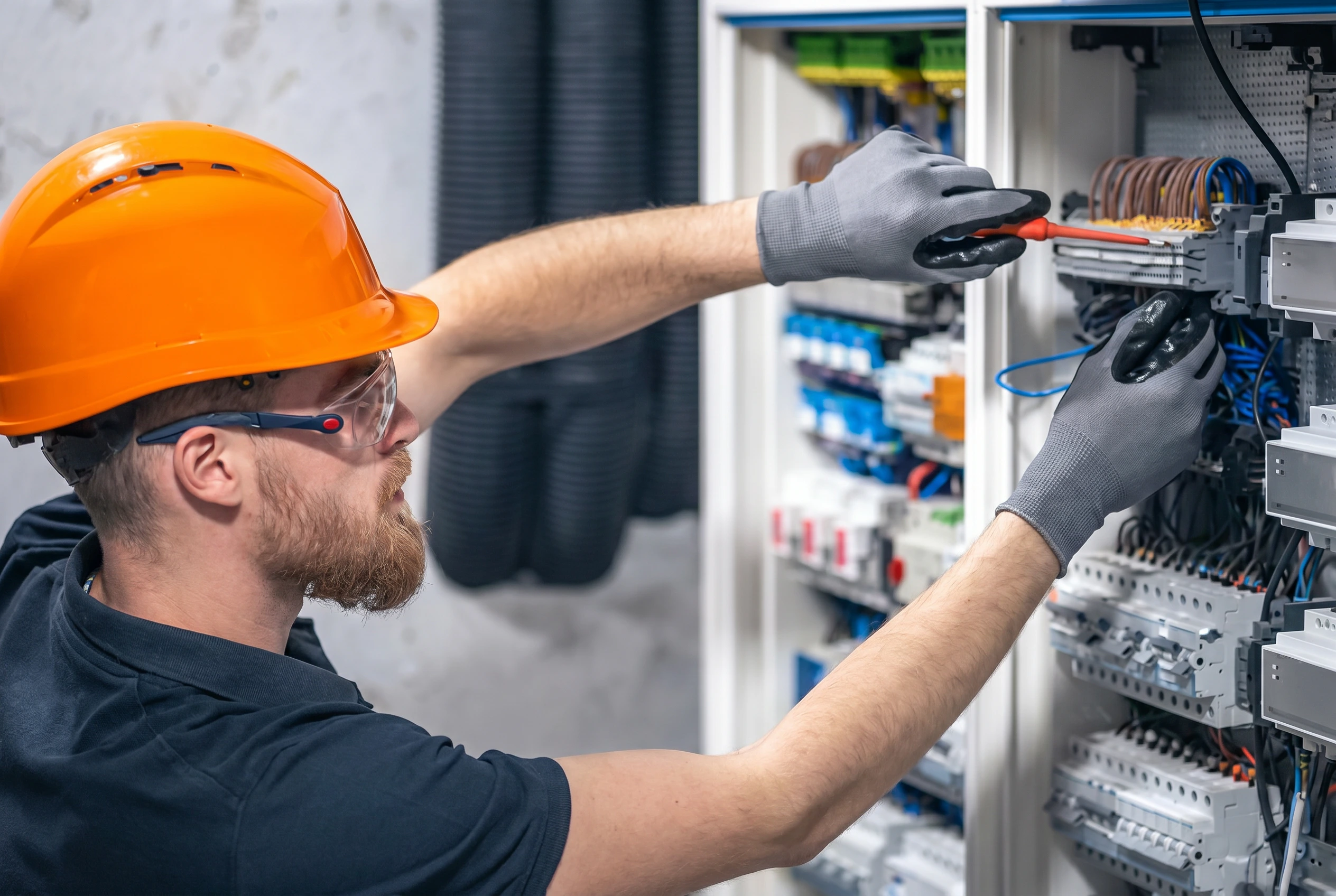 Professional engineers installing an integrated ELV security system including CCTV, access control, structured cabling and smart building technologies inside a modern commercial building in the UAE.